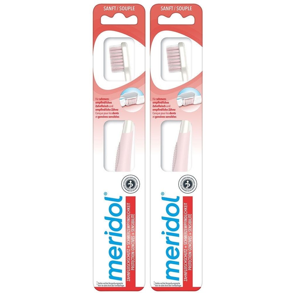 Deux brosses à dents emballées. Soies roses, manche blanc. Inscription: meridol, SANIT/SOUPLE.