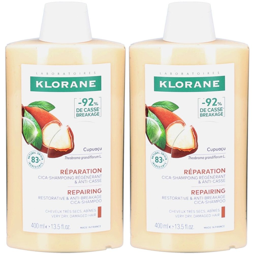 Deux flacons de shampooing KLORANE Cica. Inscriptions : -92% DE CASSE BREAKAGE, RÉPARATION, REPAIRING. Illustration de Cupuaçu et 83% d'ingrédients naturels.