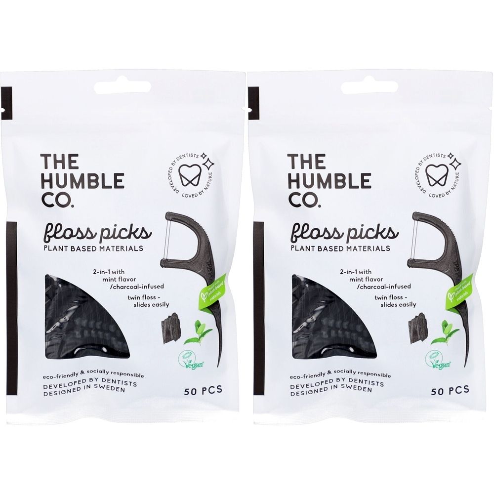 Deux paquets de fils dentaires. Emballage blanc avec texte noir: THE HUMBLE CO. Floss Picks. 50 pièces. Vegan.
