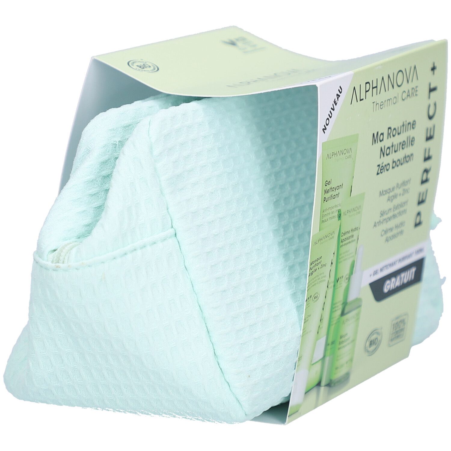 Kosmetiktasche in Verpackung. Grünliche Tasche mit Reißverschluss. Produktverpackung mit Logo und Produktnamen.