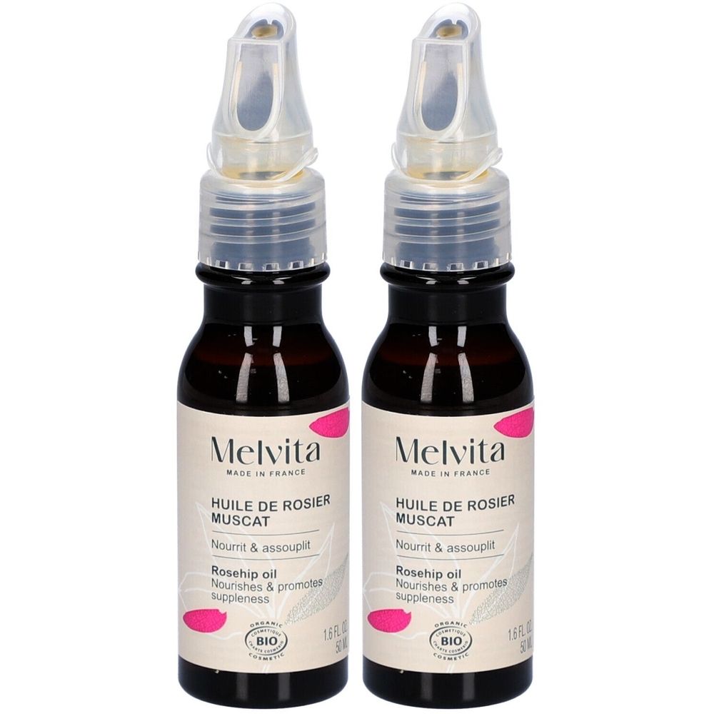 Deux flacons de MELVITA Huile de Rosier Muscat Bio. Flacons en verre brun avec applicateur. Inscription: Rosehip oil, BIO.
