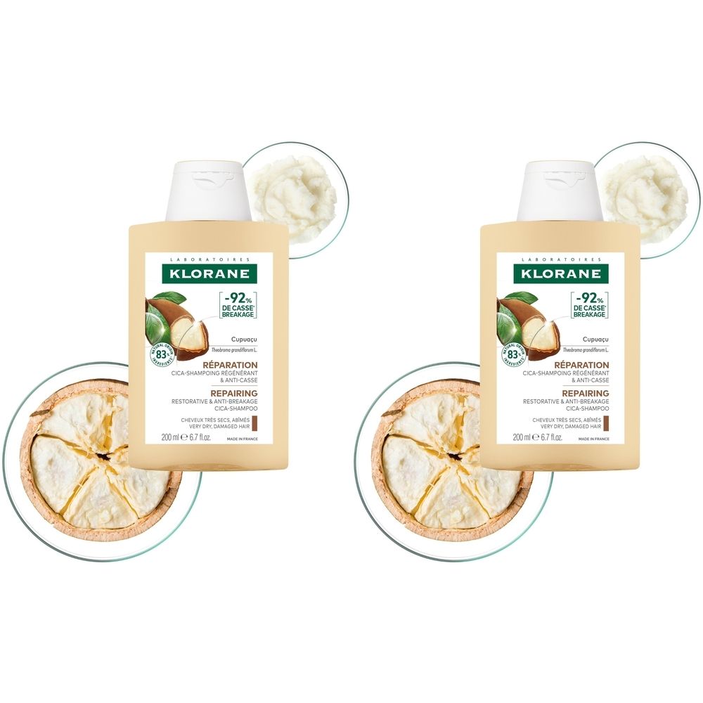 Deux flacons de shampooing KLORANE. Inscription: Cupacu Cica-Shampoing Régénérant & Anti-Casse. Crème et fruit en arrière-plan.