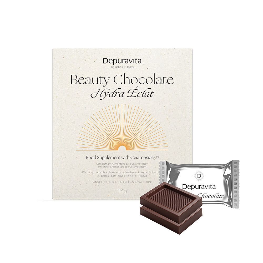 Schachtel mit Depuravita Beauty Chocolate. Zwei Schokoladenstücke und eine einzelne Schokoladenverpackung liegen daneben.
