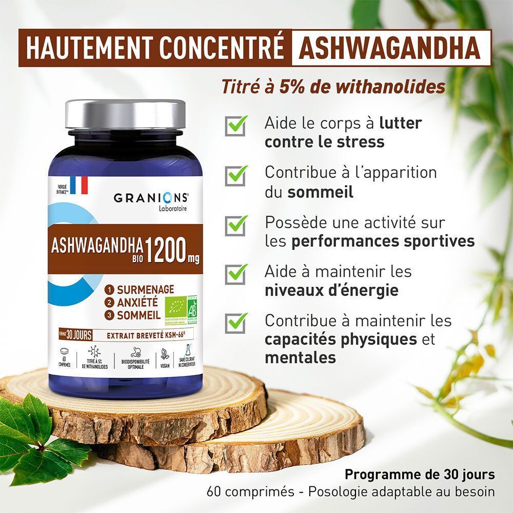Un flacon de GRANIONS Ashwagandha Bio 1200 mg sur des rondins de bois, entouré de feuilles.