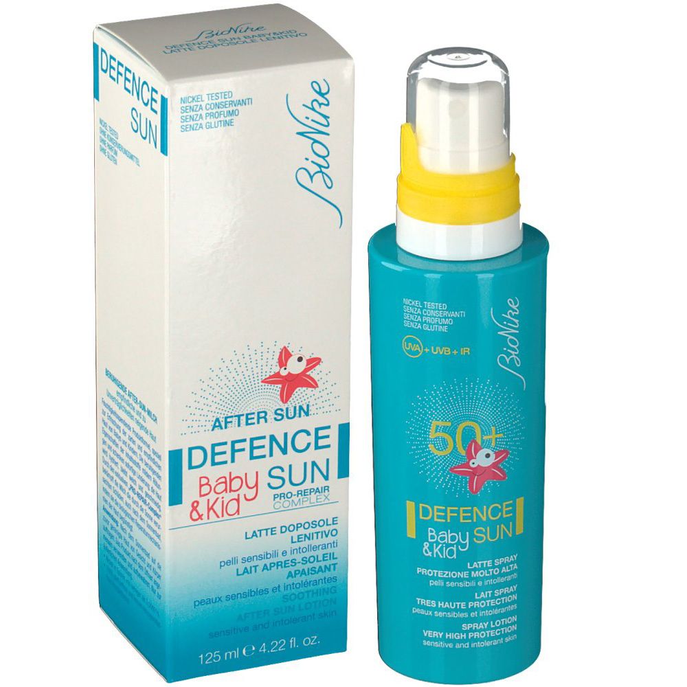 Türkisgrüne Sonnencreme-Flasche und Schachtel. Aufschrift: Defence Baby Sun & Kid, 50+. Enthält After Sun.