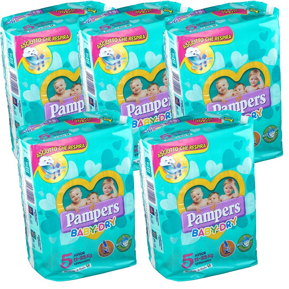Plusieurs paquets de Pampers Baby Dry Junior Taille 5. Emballage turquoise avec des images de bébés et le nom du produit.