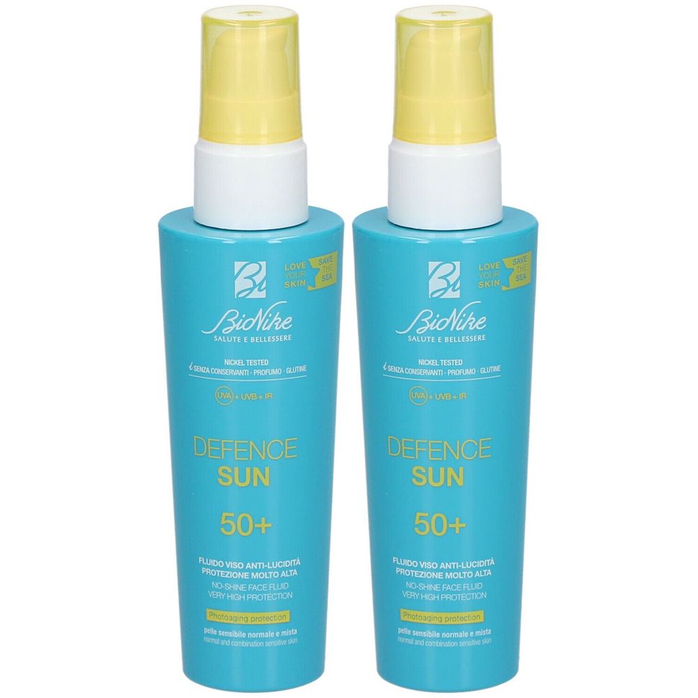 Zwei Flaschen mit blauem Körper und gelbem Sprühkopf. Aufschrift: Defence Sun 50+. Marke: BioNike.