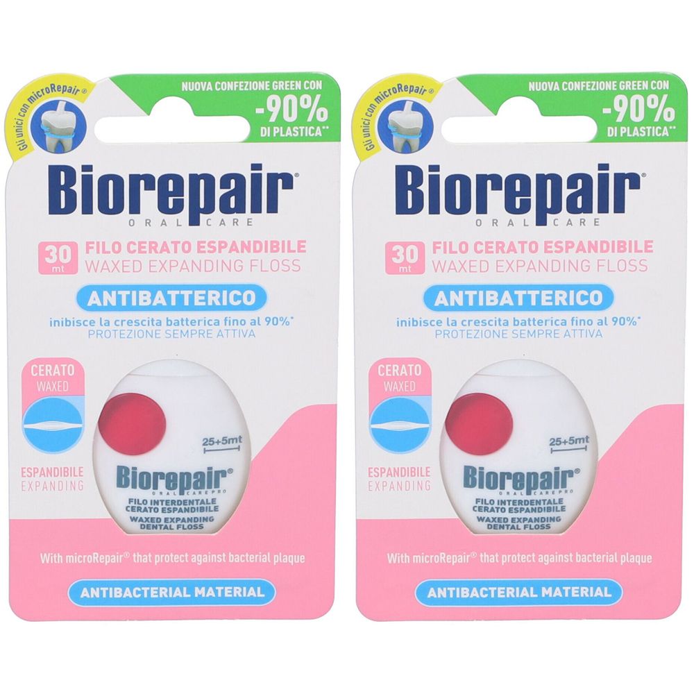 Deux paquets de fil dentaire. Emballage rose avec nom et texte du produit. Antibactérien.