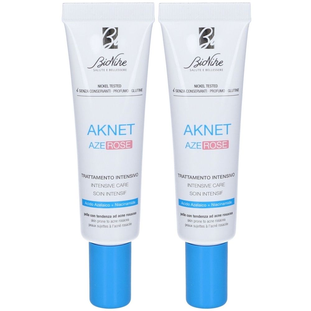 Zwei Tuben Creme. Aufschrift: AKNET AZE ROSE, Trattamento Intensivo, Intensive Care, Soin Intensif. Blaue Kappe.