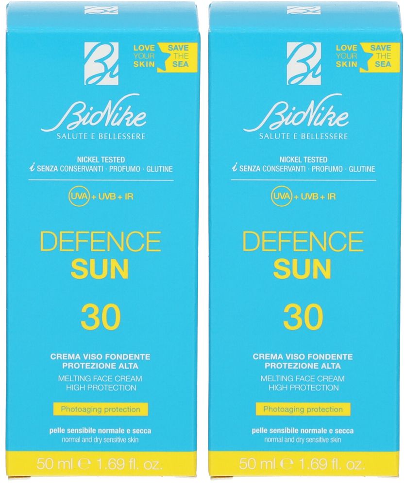 Deux boîtes bleues identiques. Inscription: BioNike Defence Sun 30, crème visage. Contient une protection UVA, UVB et IR.