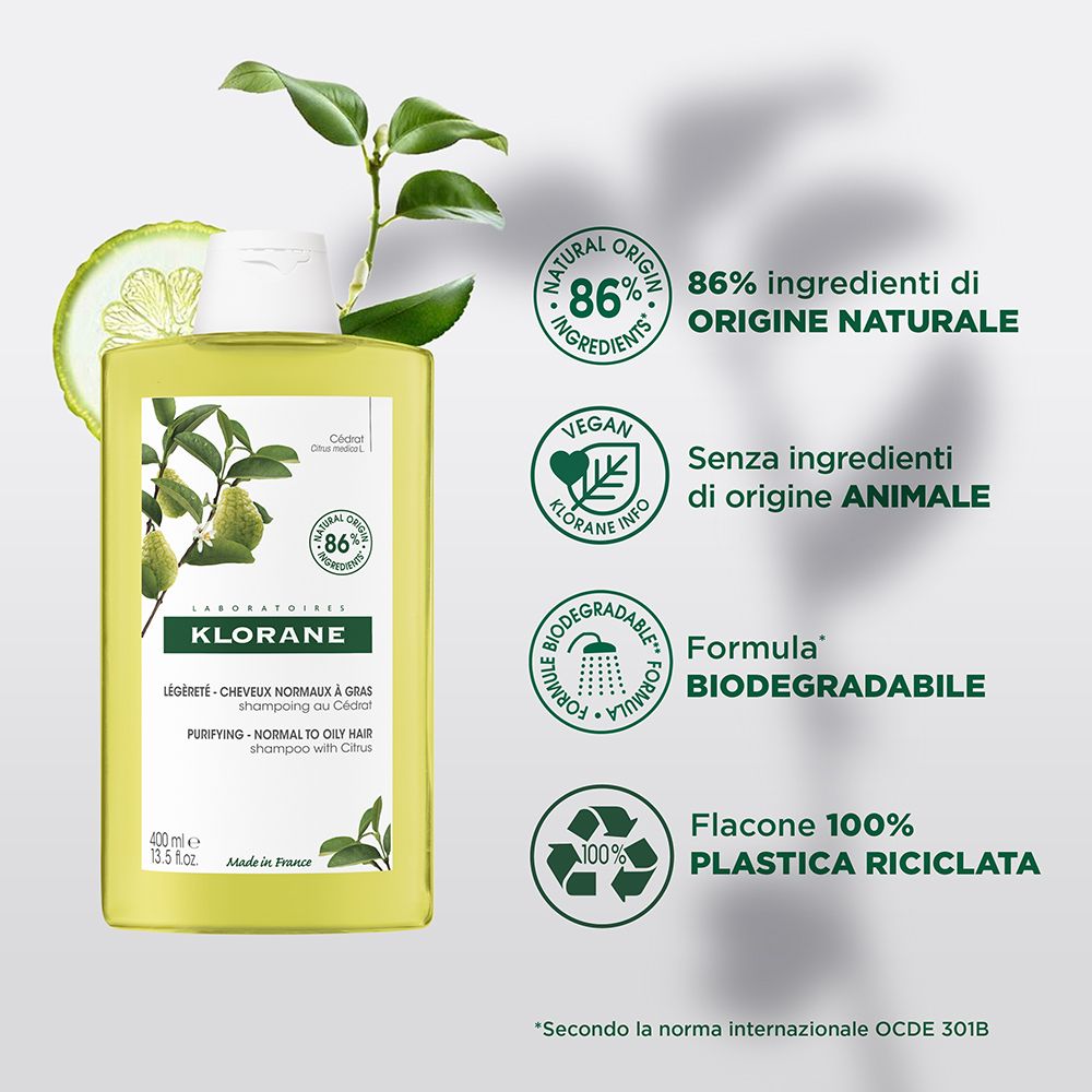 Flacon de shampooing Klorane avec agrumes et feuilles. Texte : 86% ingrédients naturels, vegan, biodégradable.