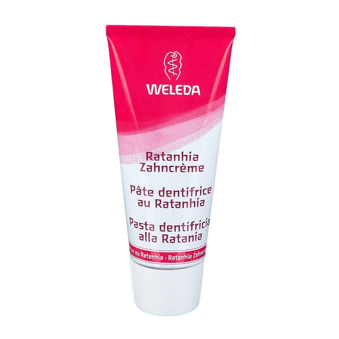 Zahnpasta-Tube, pink-weiß. Beschriftung: WELEDA, Ratanhia Zahncrème, Pâte dentifrice au Ratanhia, Pasta dentifricia alla Ratania.
