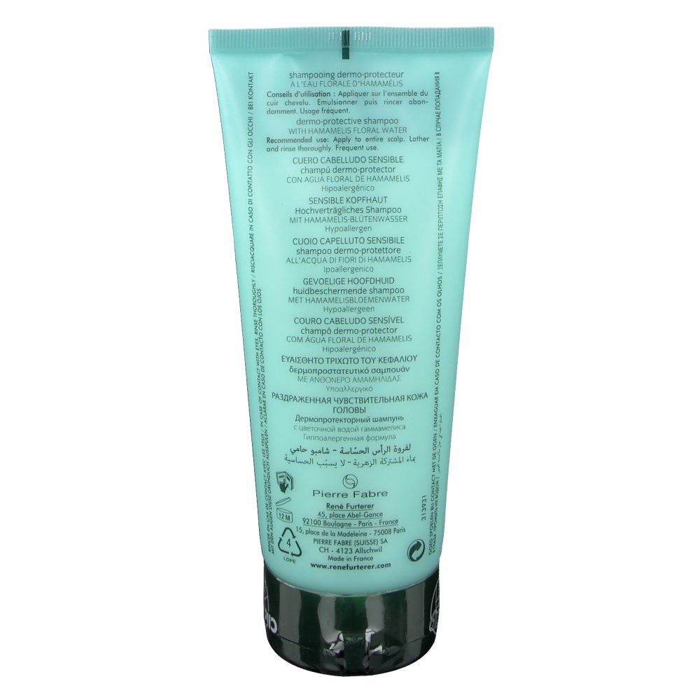 Dos du tube de shampooing bleu clair. Texte en plusieurs langues. Bouchon noir.