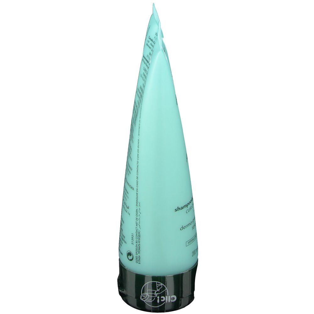 Tube de shampooing bleu clair, vue latérale. Bouchon noir. Texte sur le tube.