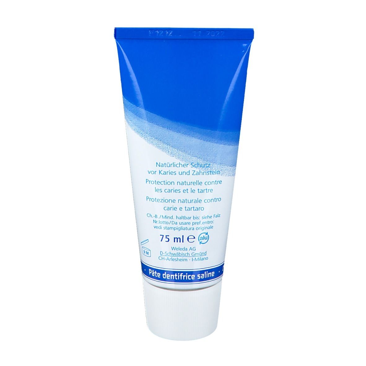 Dos du tube de dentifrice. Tube bleu avec bouchon blanc. Inscription: Protection naturelle contre les caries et le tartre.