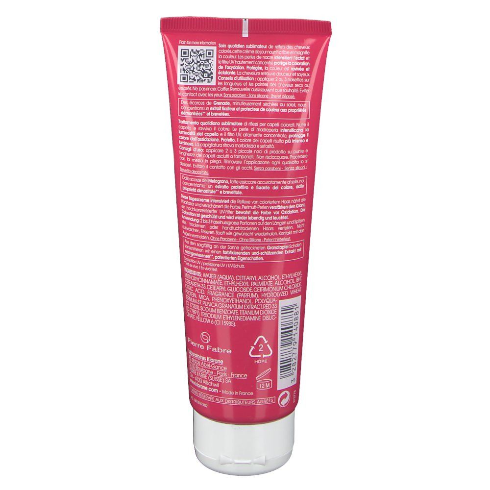 Dos d'un tube rose avec bouchon blanc. Texte et logos.