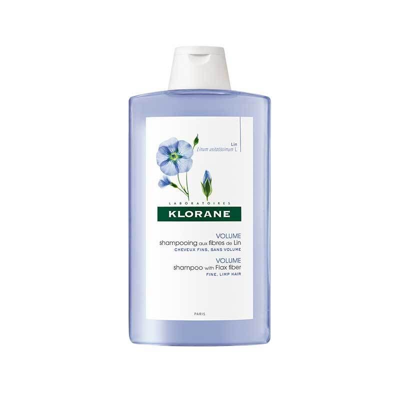 Flasche Shampoo, blau, mit weißem Deckel. Aufdruck: KLORANE, Volumen, Leinenfasern. Illustration: blaue Blume.