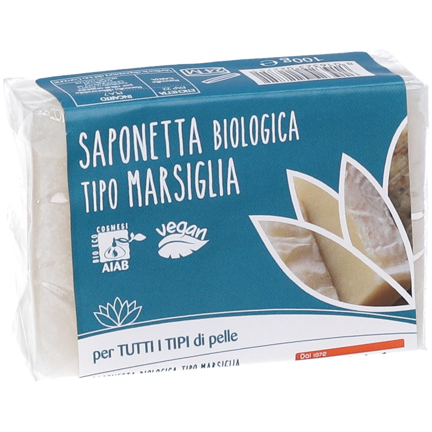 Savon emballé. Emballage bleu avec texte: Saponetta Biologica Tipo Marsiglia, logo vegan, certification AIAB, texte: per tutti i tipi di pelle.