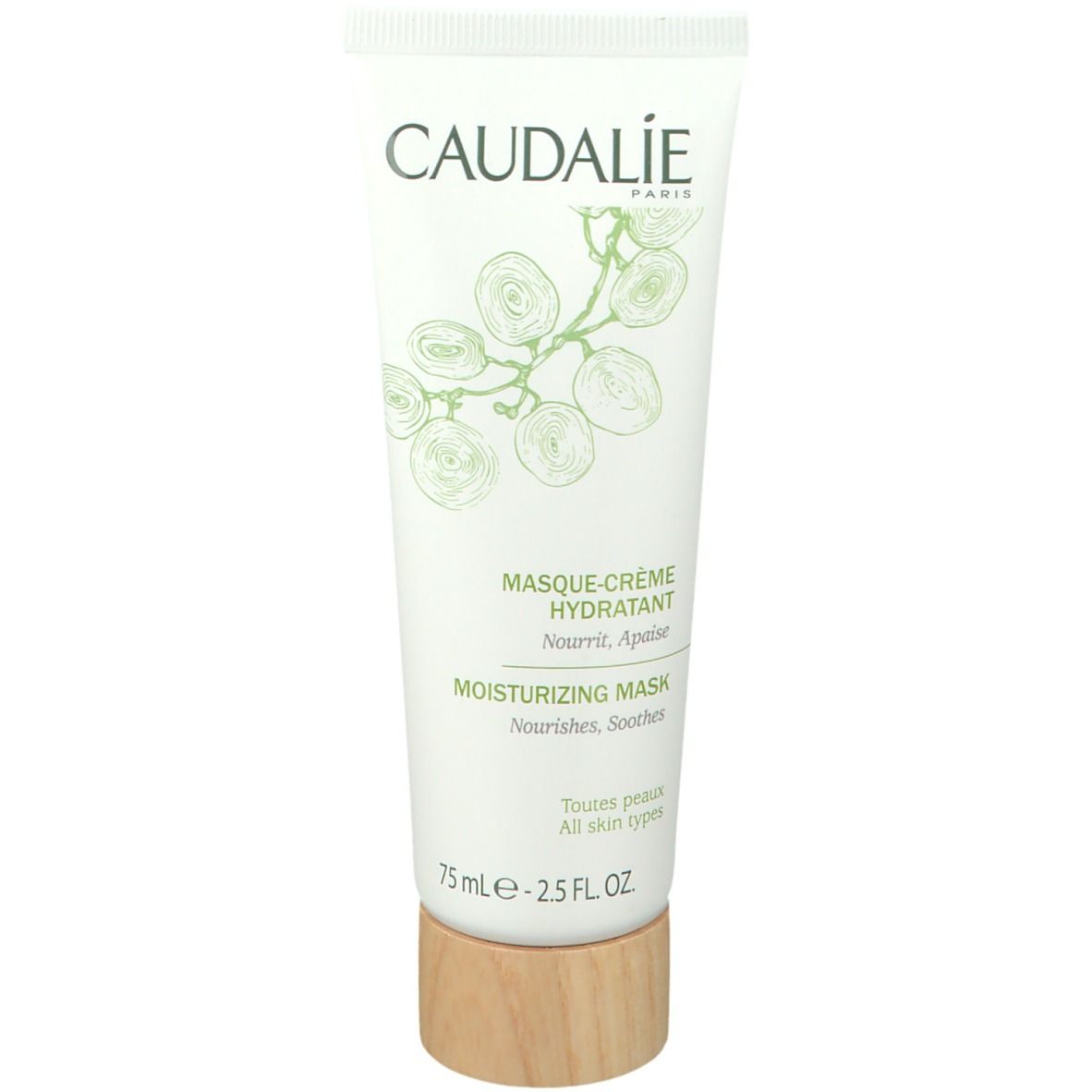Weiße Tube mit grünem Aufdruck. Text: CAUDALIE, MASQUE-CRÈME HYDRATANT, MOISTURIZING MASK. Holzfarbener Boden. 75 ml.