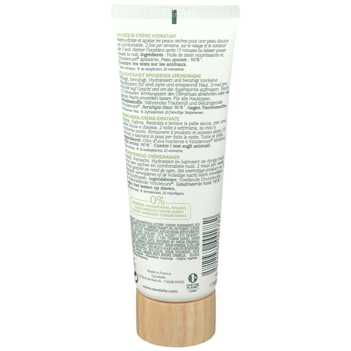 Rückseite der Tube. Text in mehreren Sprachen. Holzfarbener Boden. Inhaltsstoffe, Anwendungshinweise, Herstellerinformationen.