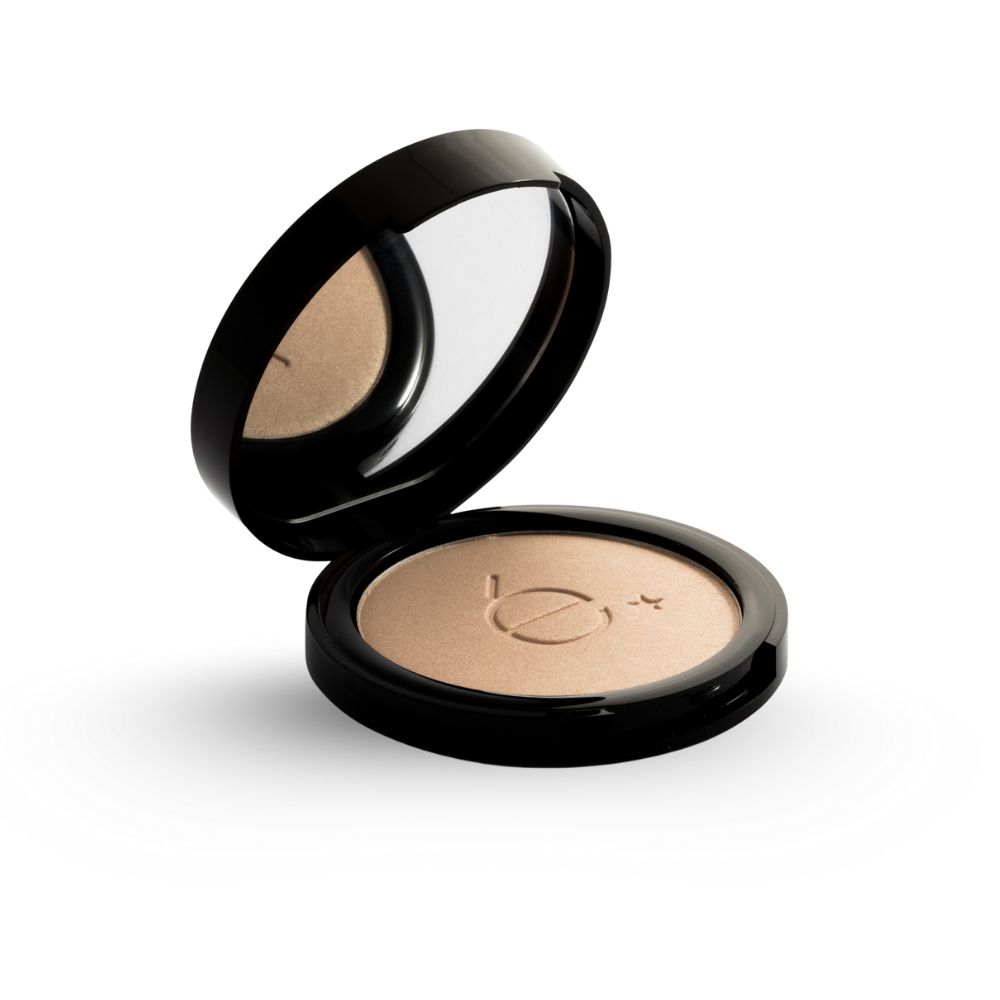 Boîtier cosmétique noir rond ouvert, miroir et poudre claire. Logo étoile. Vue oblique.