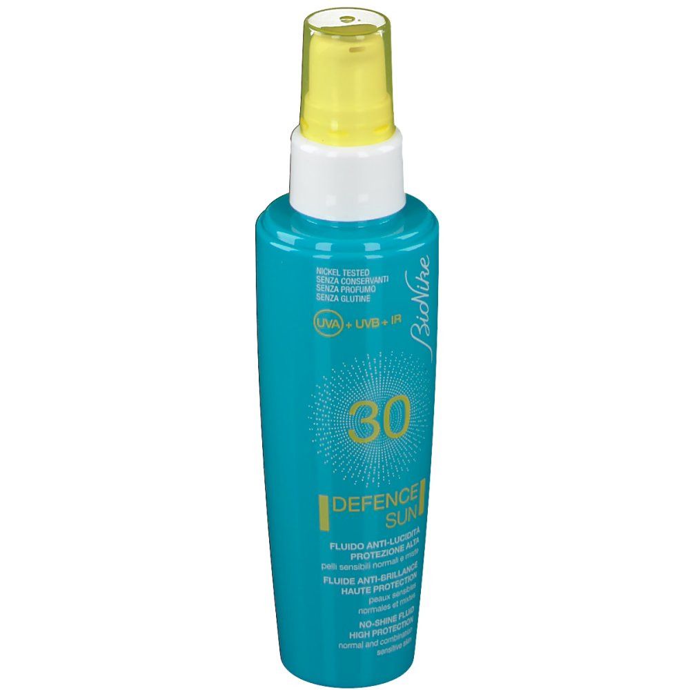 Türkisgrüne Flasche mit gelbem Sprühkopf. Aufschrift: 30, Defence Sun, Bionike. Für empfindliche Haut.