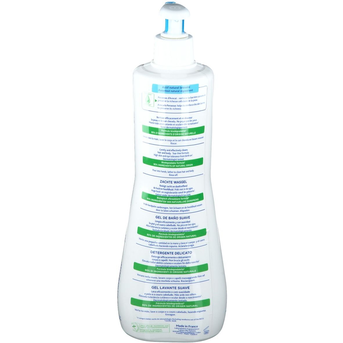 Dos du flacon blanc. Texte multilingue, écriture verte et bleue.