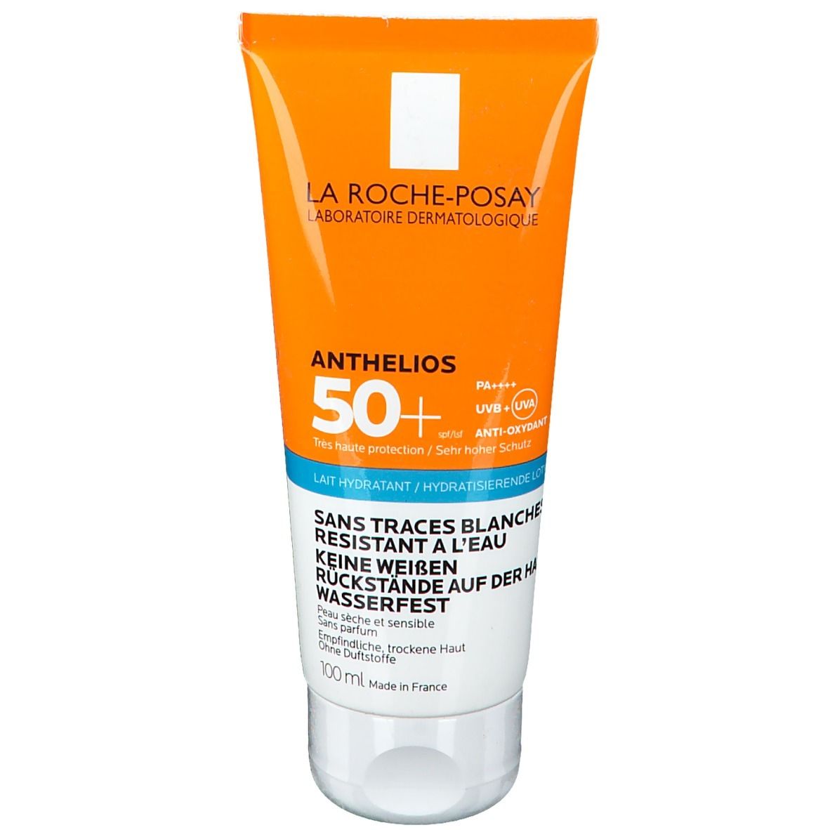 Sonnenmilch-Tube, Vorderseite. Orange-weißes Design. Produktname und SPF 50+ sichtbar. Text in mehreren Sprachen.