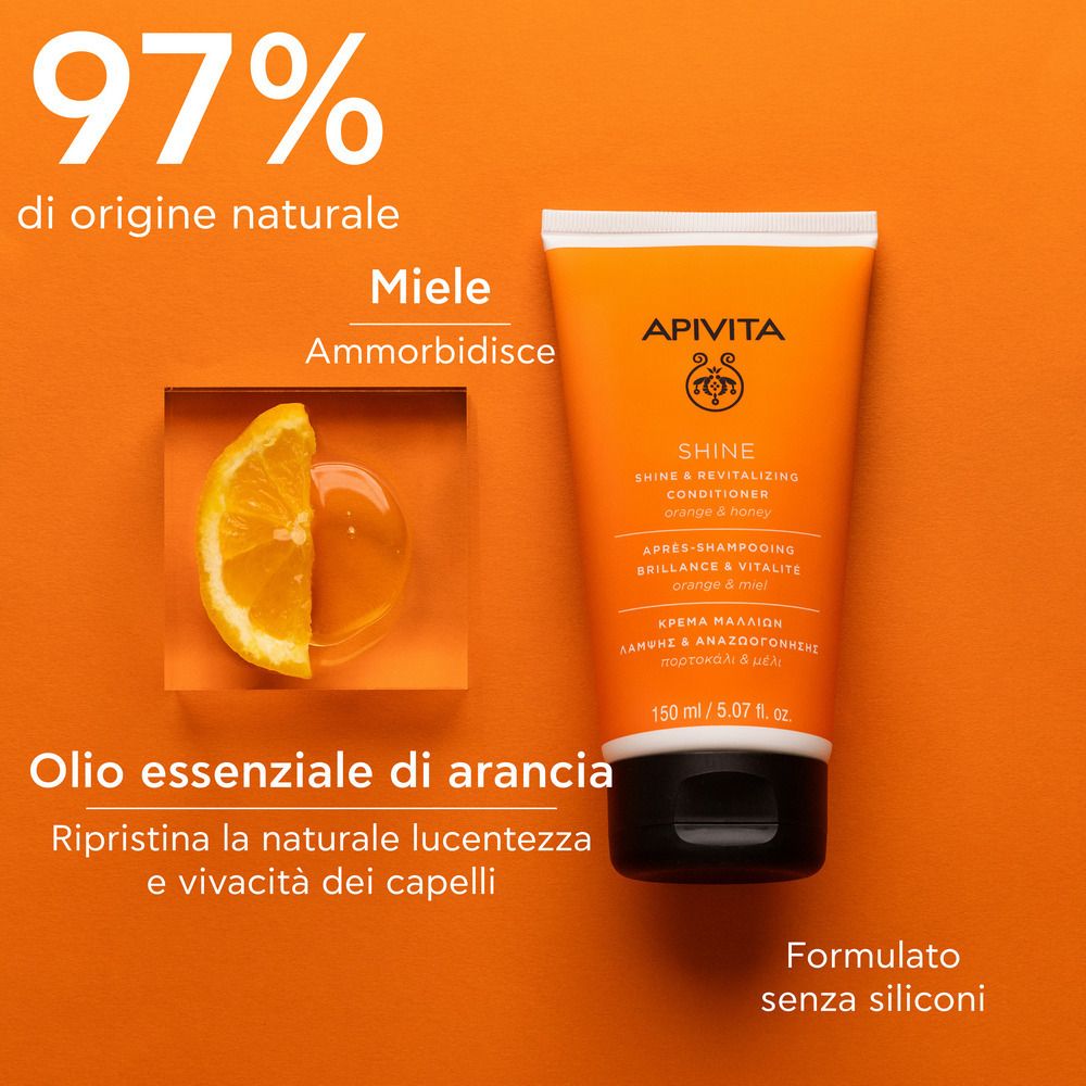 Tube orange avec bouchon blanc. Inscription: APIVITA SHINE Revitalisierender Conditioner. Texte: 97% di origine naturale, Olio essenziale di arancia.