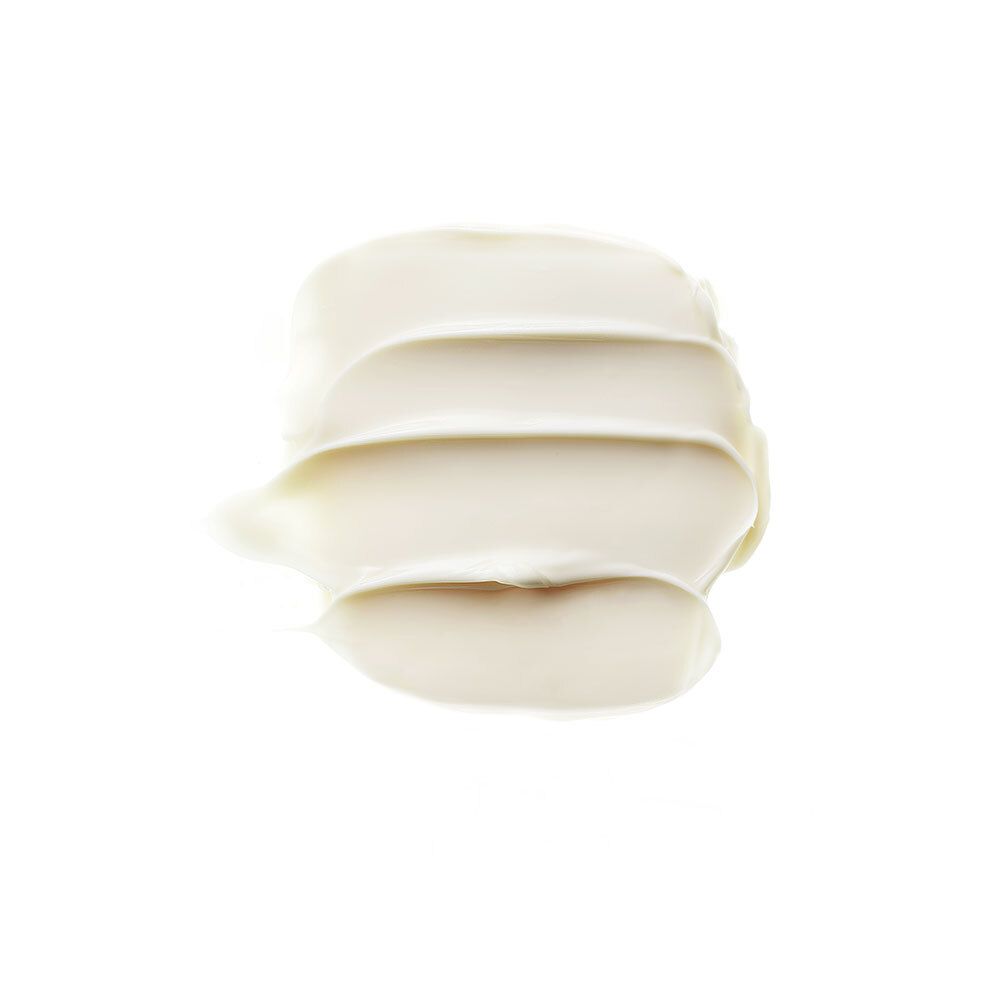 Creme-Textur. Helle, cremefarbene Creme auf weißem Hintergrund. Mehrere Streifen.