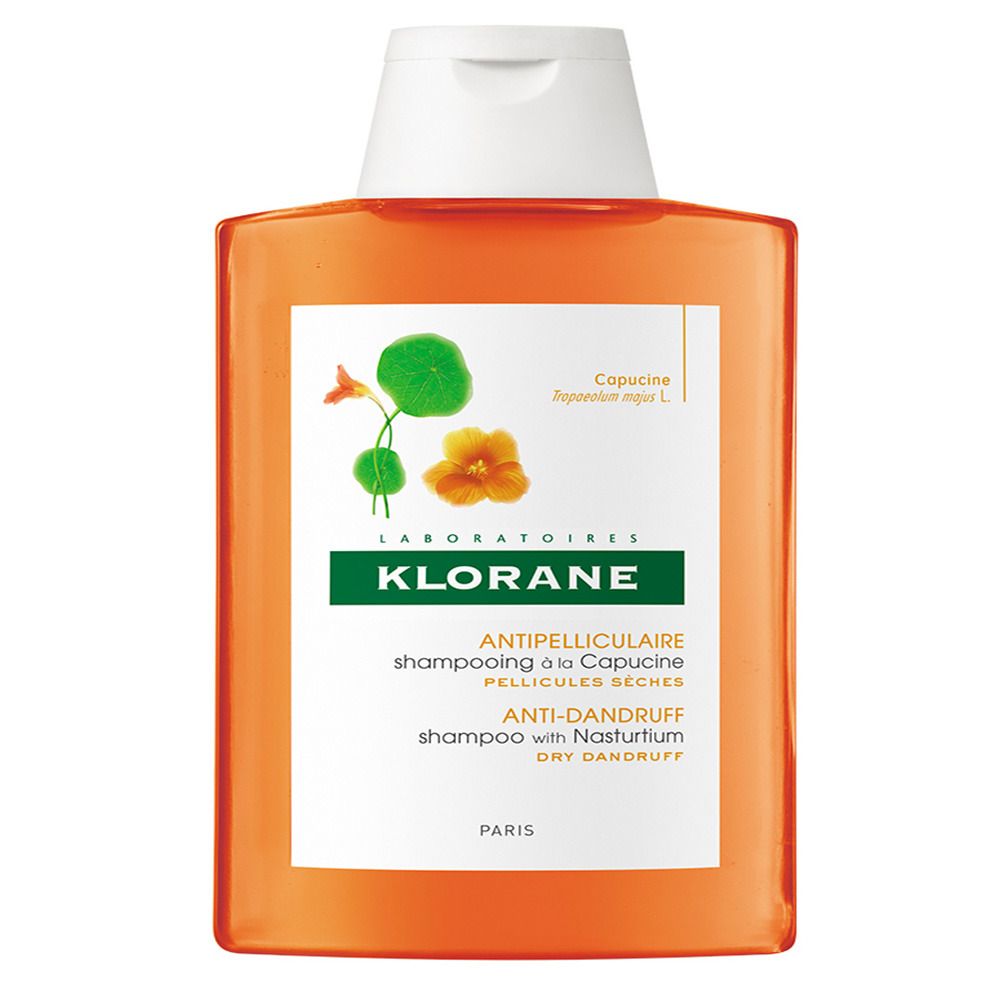Orangefarbene Shampoo-Flasche mit weißem Deckel. Aufschrift: KLORANE, Anti-Schuppen Shampoo mit Kapuzinerkresse.