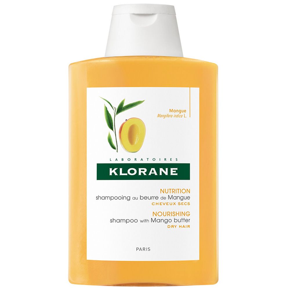 Flacon de shampooing jaune avec bouchon blanc. Inscription: KLORANE, shampooing au beurre de mangue. Illustration de mangue.