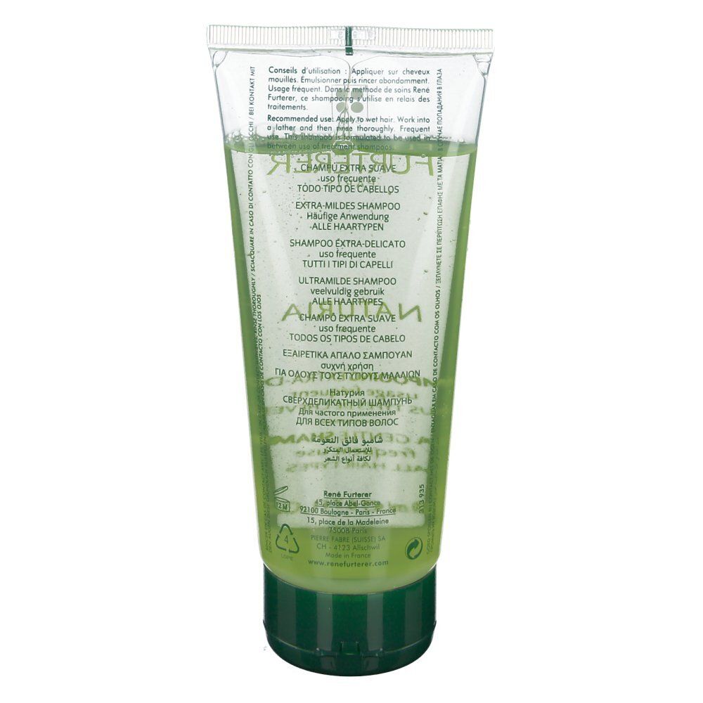 Tube transparent de shampooing. Inscription: FURTERER PARIS, NATURIA, Shampooing extra-doux. Pour tous types de cheveux. Dos.