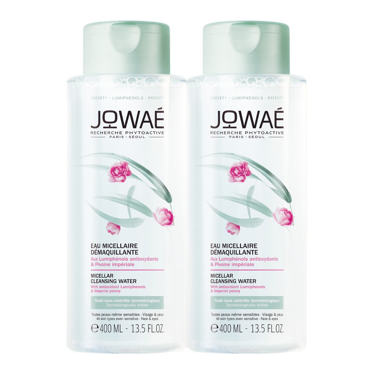 Zwei Flaschen Mizellenwasser. Klare Flüssigkeit in zylindrischen Flaschen mit grünen Deckeln. Aufdruck mit Produktname und floralem Design.