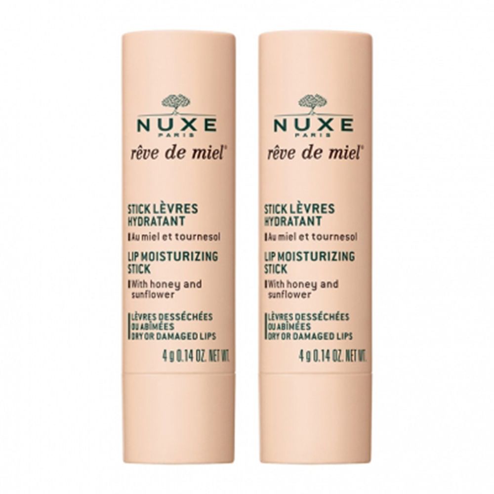 Deux sticks à lèvres. Tubes beiges avec texte. Marque NUXE, nom du produit Rêve de Miel, texte: Stick Lèvres Hydratant.