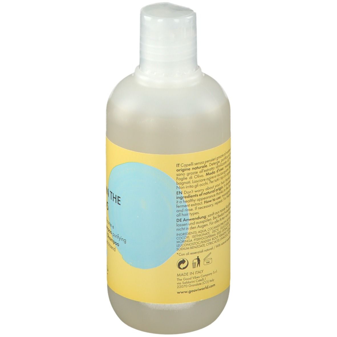 Rückseite der Goovi Shampoo-Flasche. Gelbes Etikett mit Text und Inhaltsangaben. Transparente Flüssigkeit sichtbar.