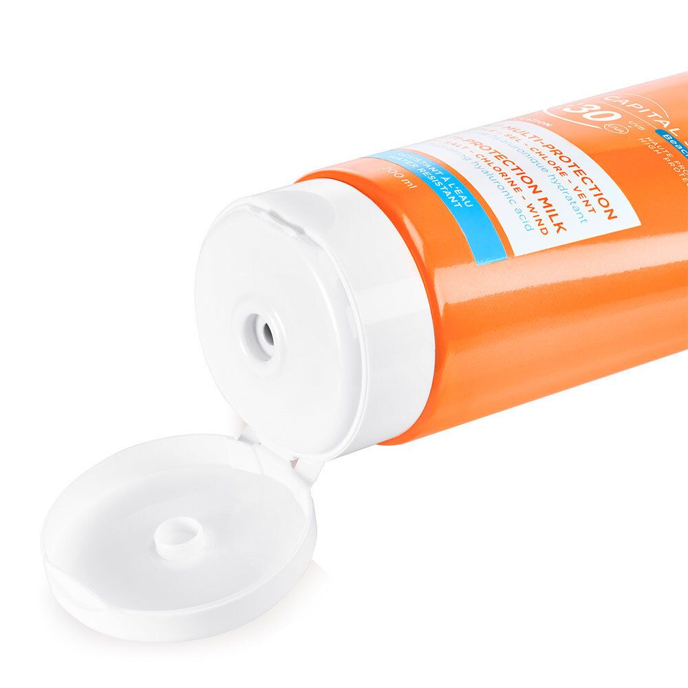 Gros plan du bouchon ouvert d'un tube orange. Le bouchon est blanc.