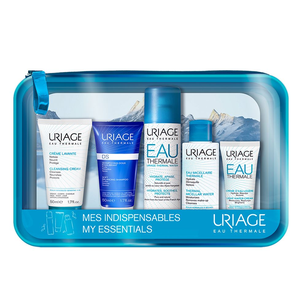 Trousse transparente bleue contenant cinq produits Uriage. Inscriptions: Uriage, Eau Thermale, Mes Indispensables.