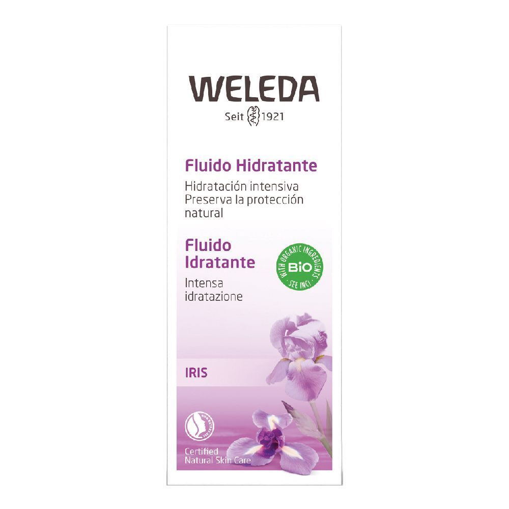 Weleda-Gesichtsfluid-Verpackung. Weiß, mit lila Akzenten und Iris-Blüten. Text: „Fludio Idratante“ und „Bio“ Siegel.