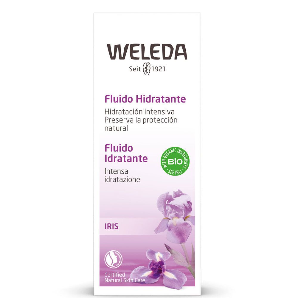 Weleda-Gesichtsfluid-Verpackung. Weiß, mit lila Akzenten und Iris-Blüten. Text: „Fludio Idratante“ und „Bio“ Siegel.