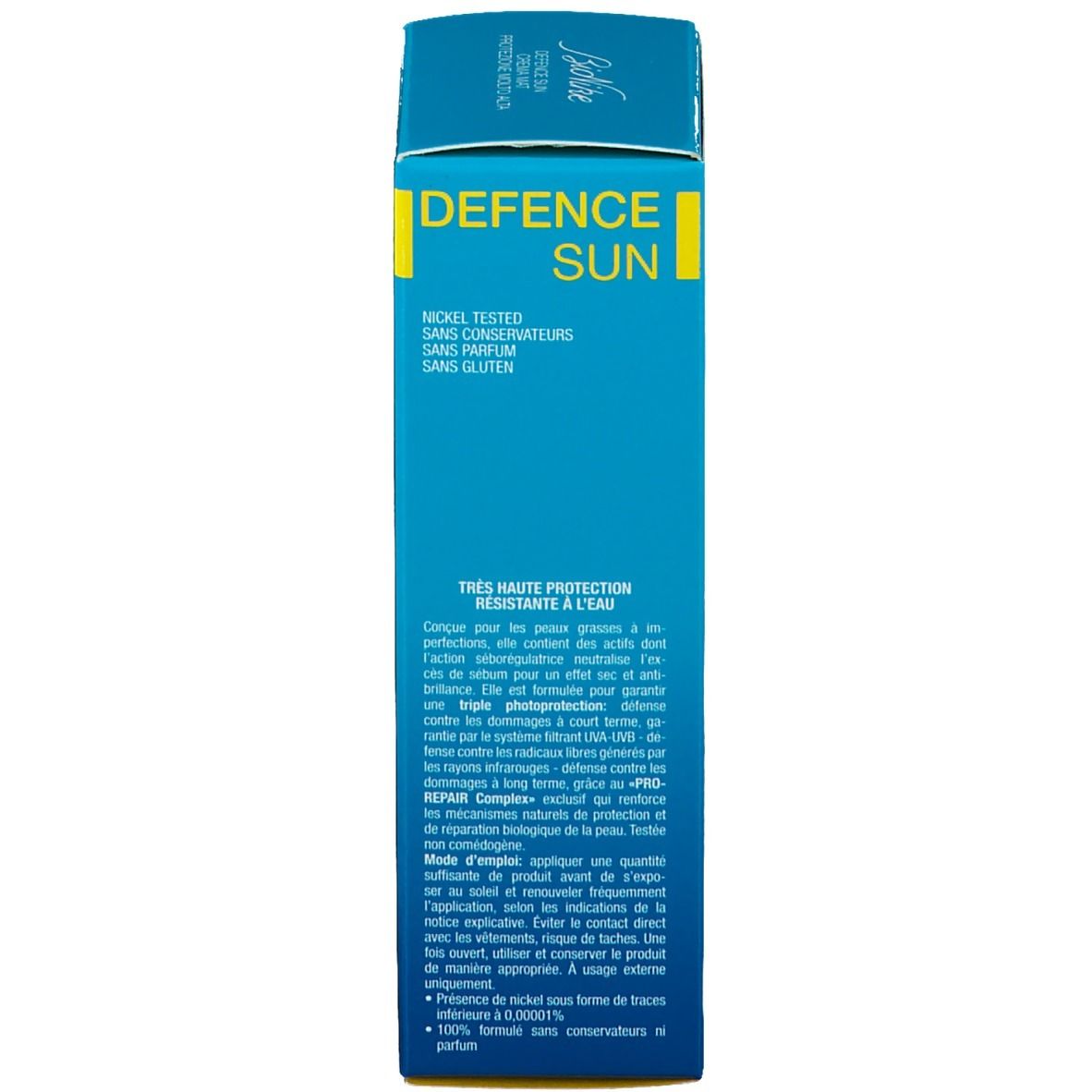 Rückseite der türkisfarbenen Schachtel. Text in mehreren Sprachen. Aufschrift: Defence Sun. Marke: BioNike. Mit Inhaltsstoffen.