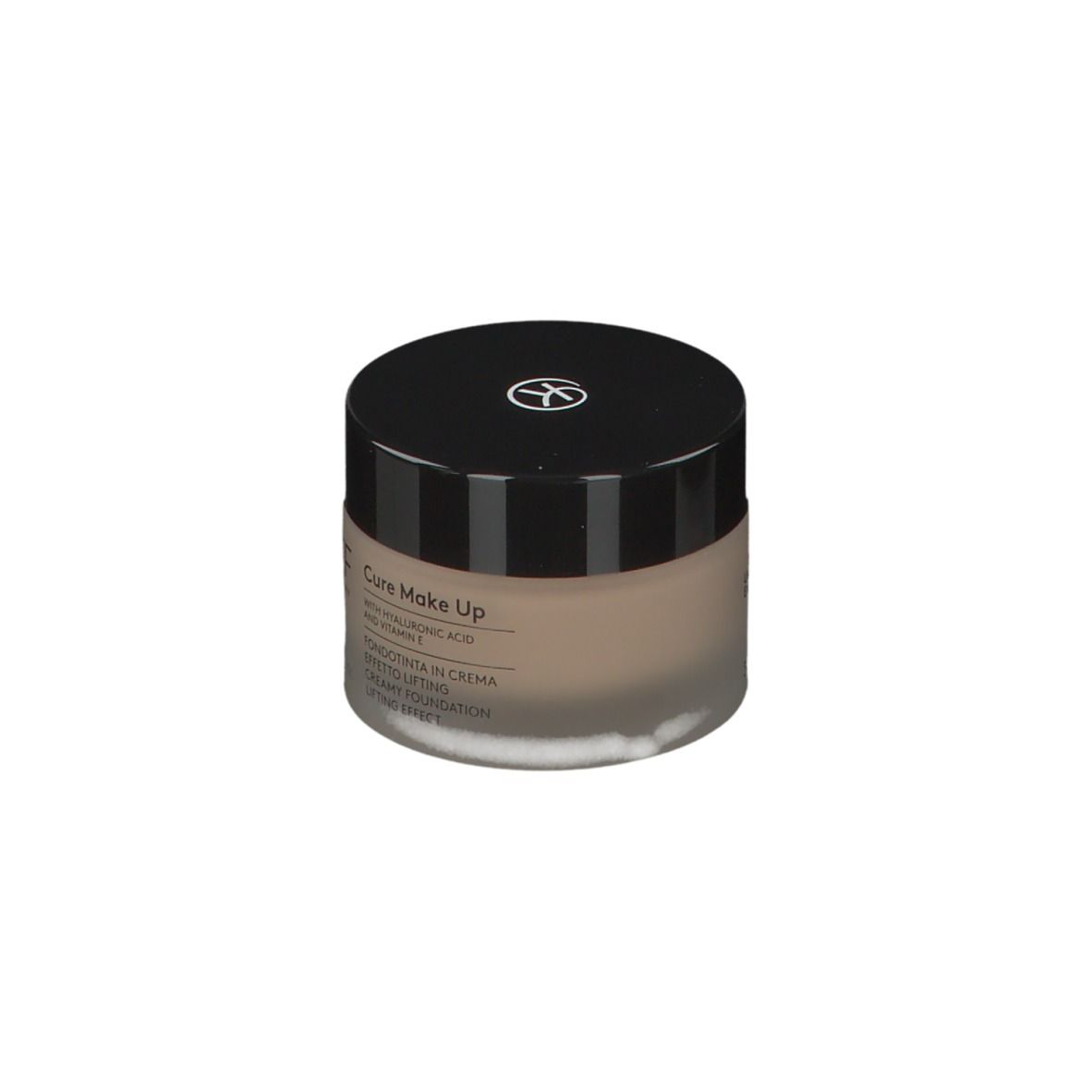 Crème beige dans un pot rond avec un couvercle noir. Un logo est sur le couvercle. KORFF Cure Make Up est écrit sur le pot.
