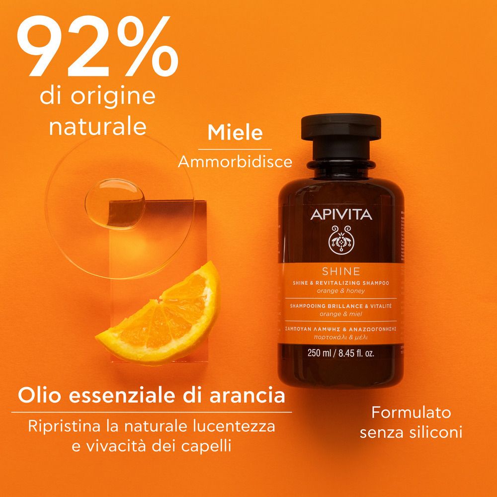 Flacon de shampooing avec orange et miel. Texte : 92% d'origine naturelle, miel, huile d'orange. Sans silicones.