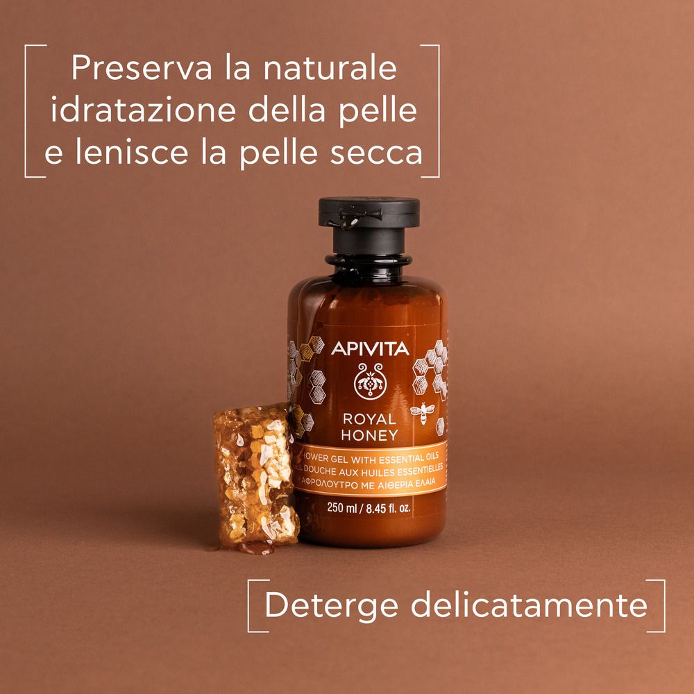 Flacon marron avec bouchon noir. Texte : APIVITA ROYAL HONEY. Nid d'abeilles à côté. Boîte de texte : Nettoie en douceur.