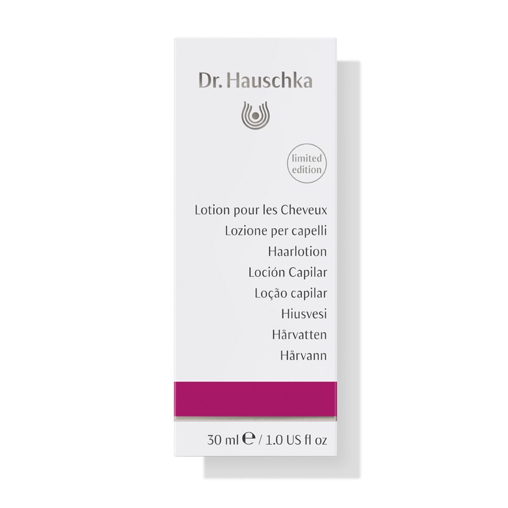 Emballage blanc avec nom du produit en plusieurs langues. Contient 'Lotion pour les Cheveux'.