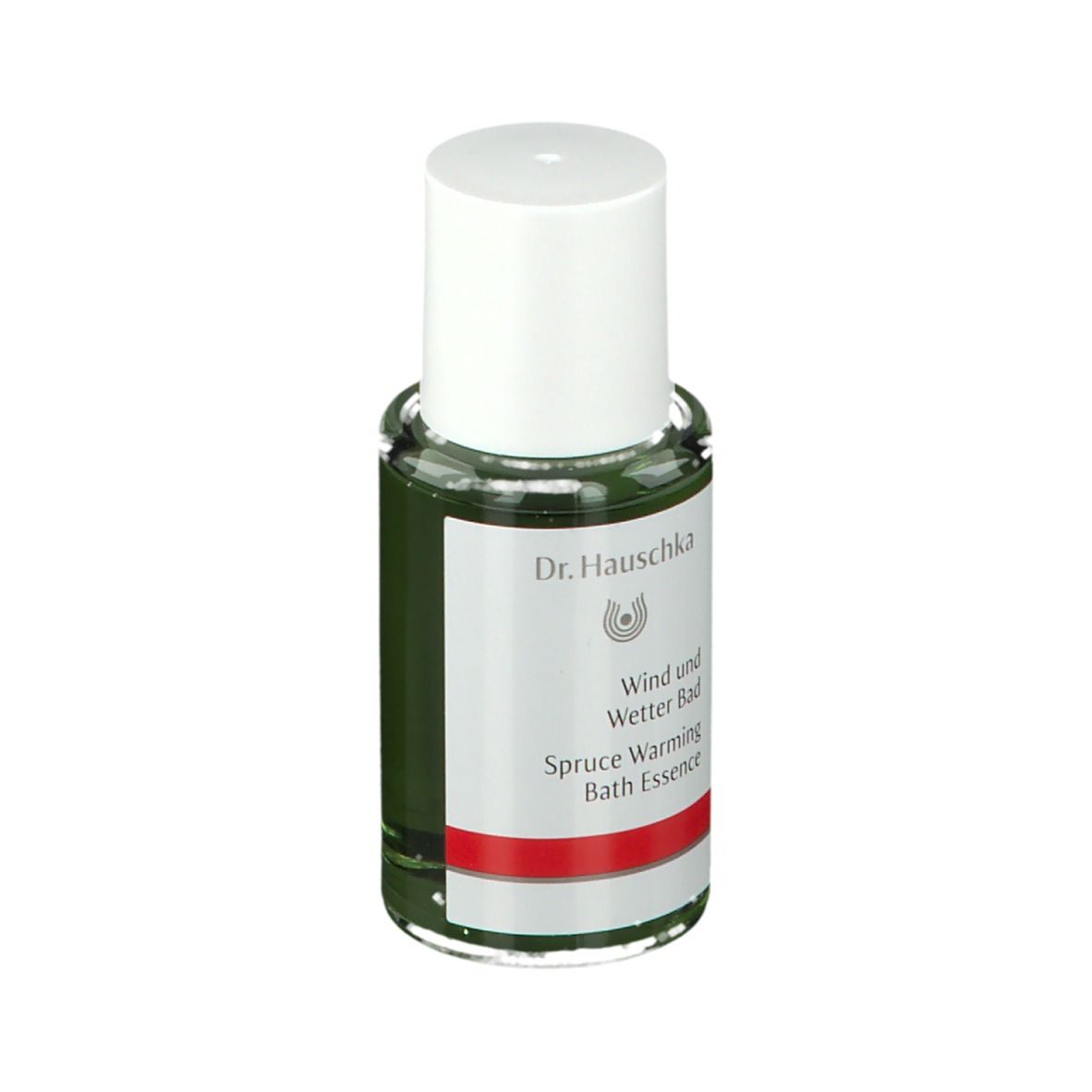 Flacon en verre vert avec bouchon blanc. Étiquette avec logo Dr. Hauschka et texte: Wind und Wetter Bad, Spruce Warming Bath Essence.