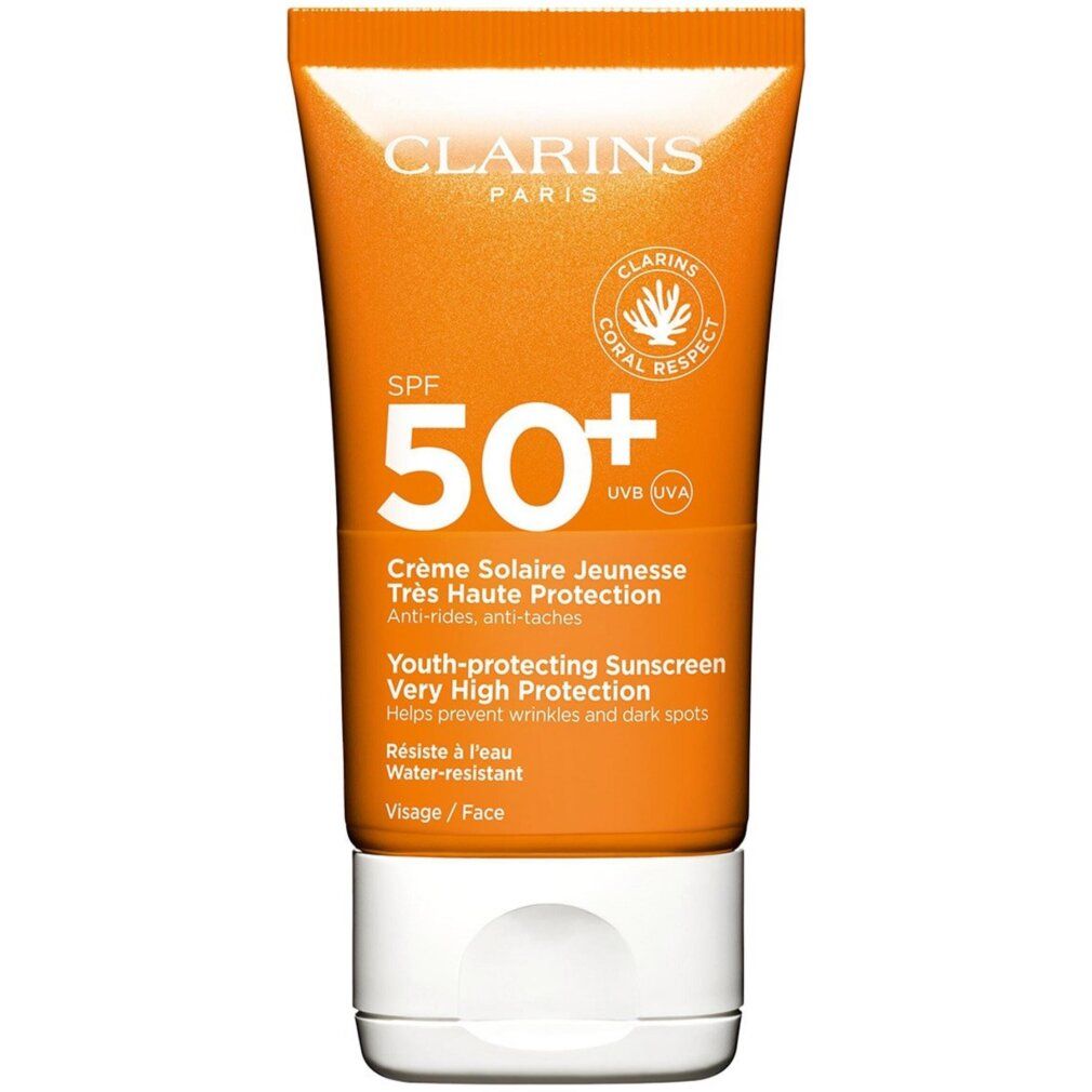 Crème solaire Clarins SPF 50+ visage. Tube orange, bouchon blanc, logo corail.