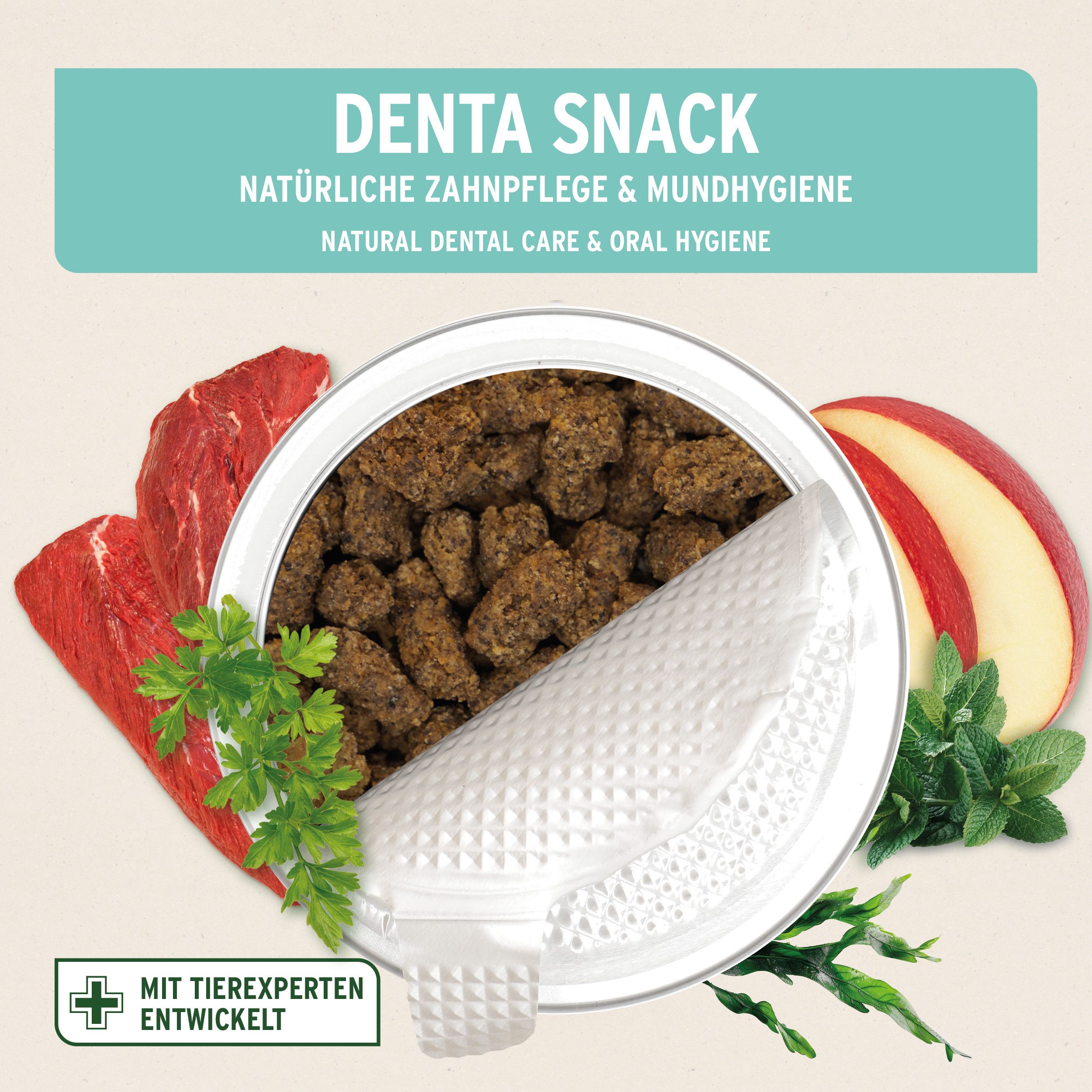 Geöffnete Dose mit Denta Snack. Daneben Fleisch, Apfelstücke, Kräuter. Text: Natürliche Zahnpflege & Mundhygiene.